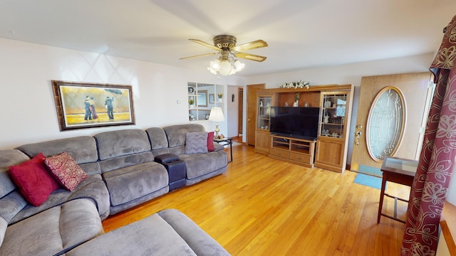 living room featuring ceiling fan and light hardwood / wood-style flooring