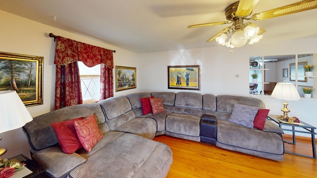 living room with light hardwood / wood-style flooring and ceiling fan