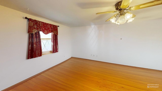 empty room with ceiling fan and wood-type flooring