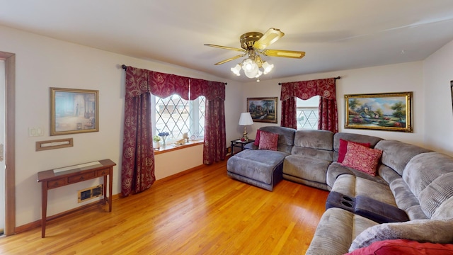 living room featuring ceiling fan, plenty of natural light, and light hardwood / wood-style flooring