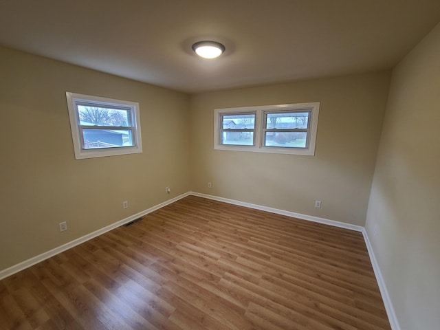 spare room with hardwood / wood-style floors