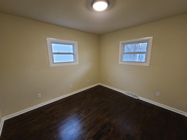 empty room featuring dark wood-type flooring