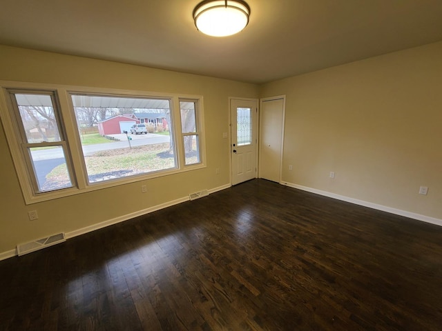 unfurnished room featuring dark hardwood / wood-style floors