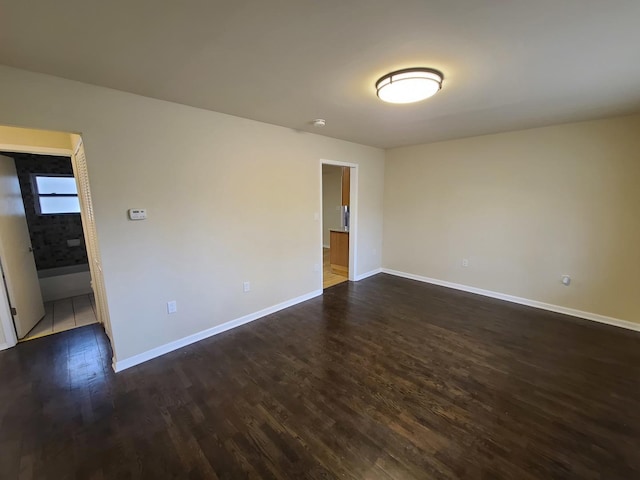 empty room featuring dark hardwood / wood-style flooring