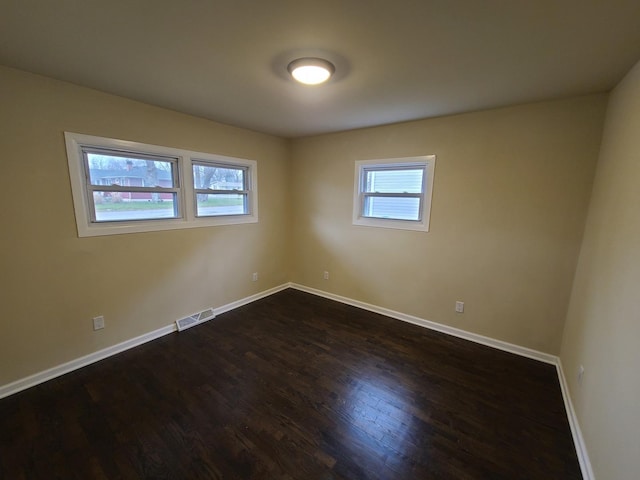 spare room featuring dark wood-type flooring