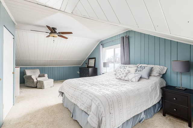 carpeted bedroom with ceiling fan and vaulted ceiling