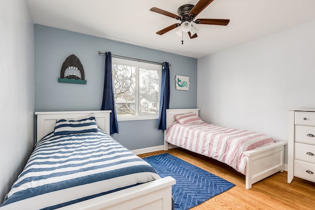 bedroom with light hardwood / wood-style floors and ceiling fan