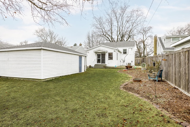 rear view of property with a yard