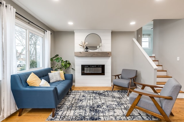 living room with hardwood / wood-style flooring and a fireplace