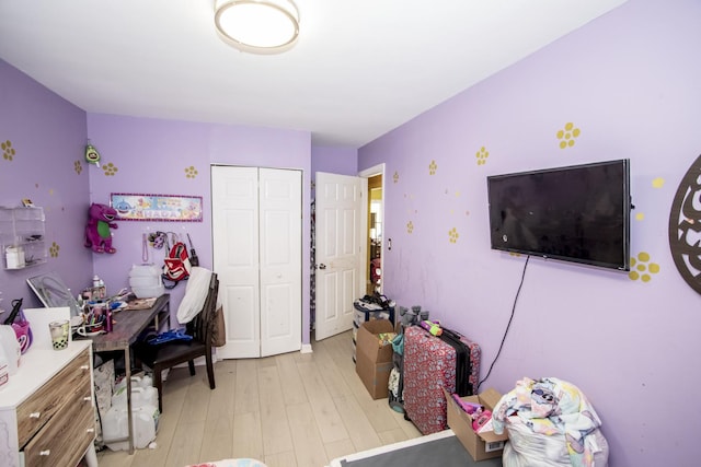 bedroom featuring light hardwood / wood-style flooring and a closet