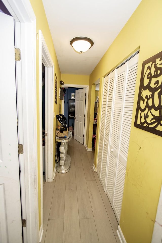 corridor with light hardwood / wood-style floors