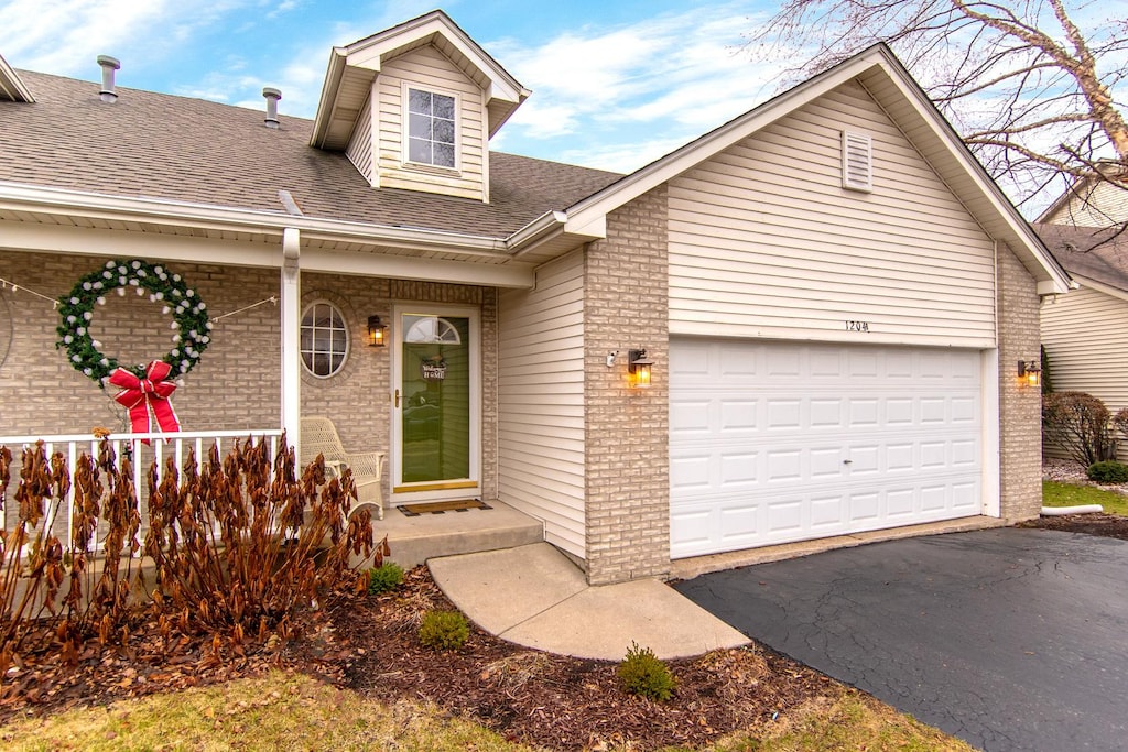 view of front of property featuring a garage and covered porch