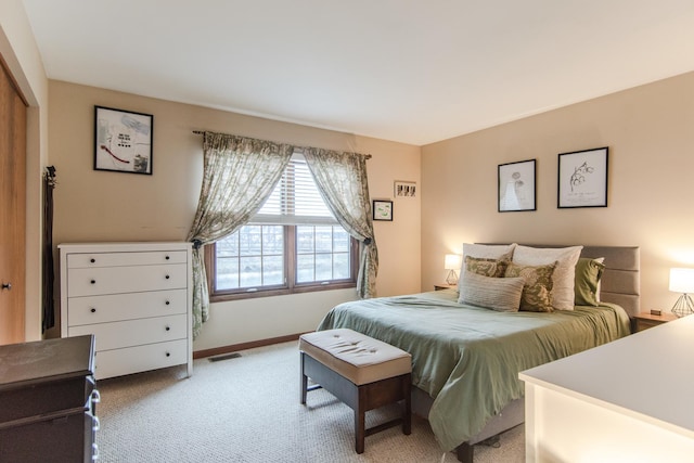 bedroom featuring light carpet