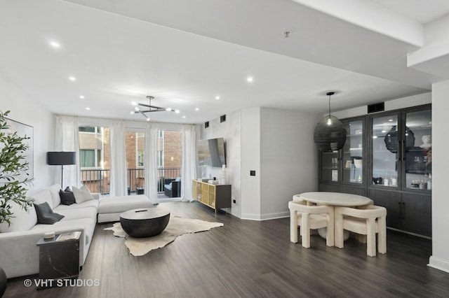 living room featuring a chandelier and dark hardwood / wood-style flooring