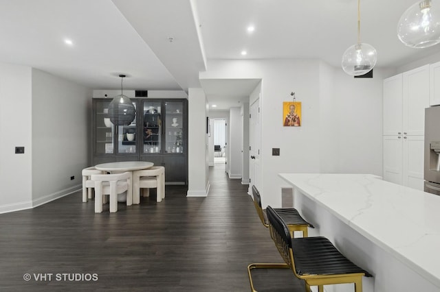 dining space featuring dark wood-type flooring