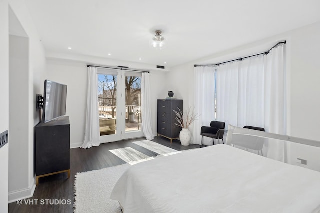 bedroom featuring dark hardwood / wood-style flooring and access to exterior