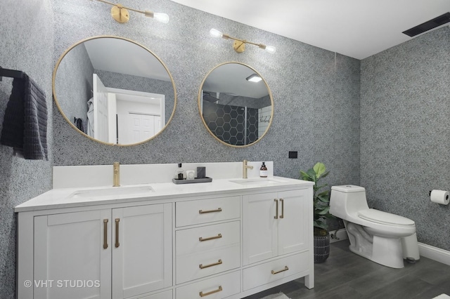 bathroom featuring vanity, toilet, and hardwood / wood-style floors