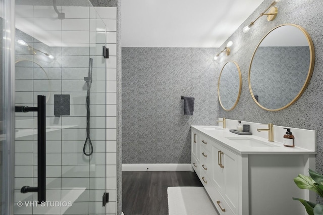 bathroom featuring vanity, hardwood / wood-style floors, and a shower with shower door