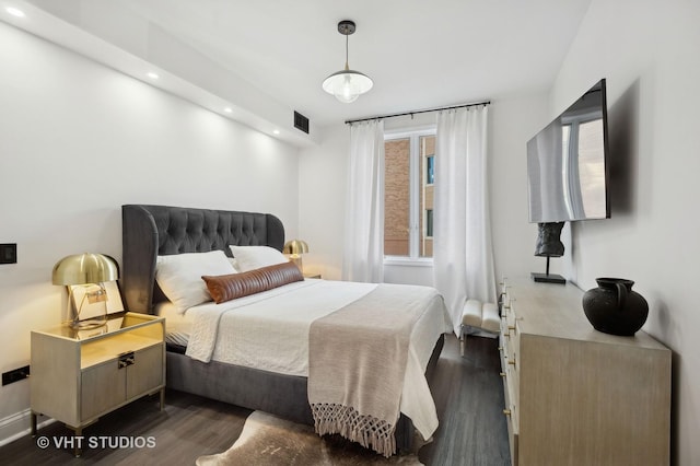 bedroom with dark wood-type flooring