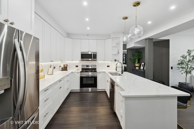 kitchen with stainless steel appliances, sink, hanging light fixtures, and white cabinets