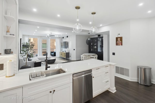 kitchen with pendant lighting, sink, light stone counters, white cabinets, and stainless steel dishwasher