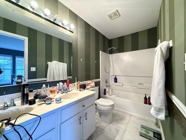 full bathroom featuring vanity, tile patterned floors, shower / washtub combination, and toilet