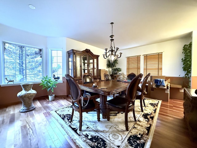 dining room featuring a notable chandelier and hardwood / wood-style flooring