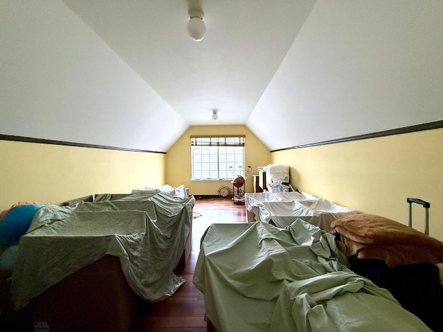 bedroom with hardwood / wood-style flooring and vaulted ceiling