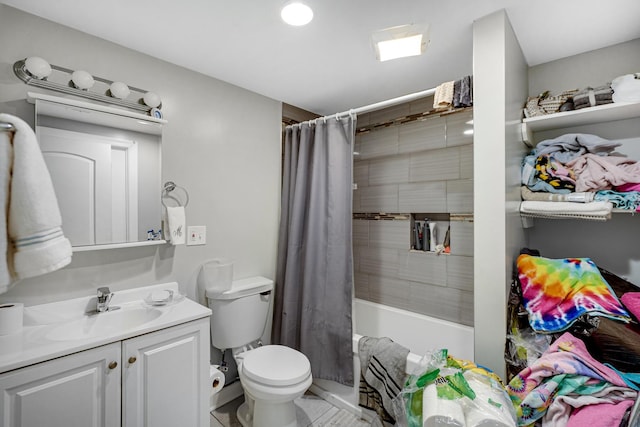 full bathroom with vanity, shower / tub combo with curtain, and toilet