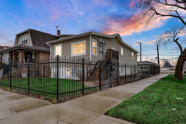 property exterior at dusk with a lawn