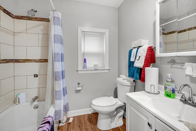 full bathroom featuring vanity, hardwood / wood-style floors, shower / bath combo, and toilet