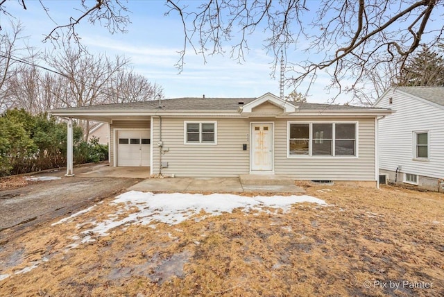 ranch-style house with a garage and driveway