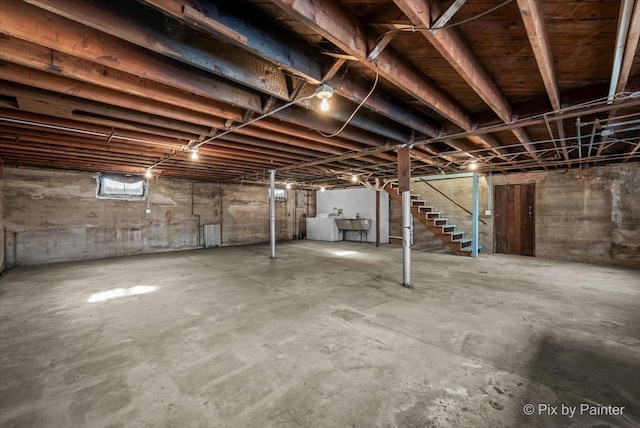 basement featuring stairs and washer and dryer