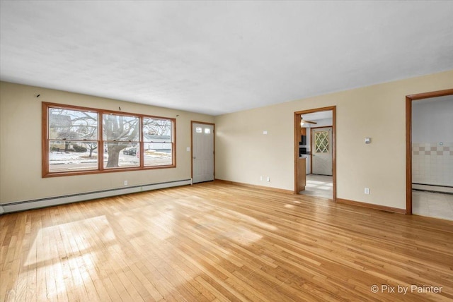 unfurnished living room with light wood finished floors, a baseboard radiator, and baseboards