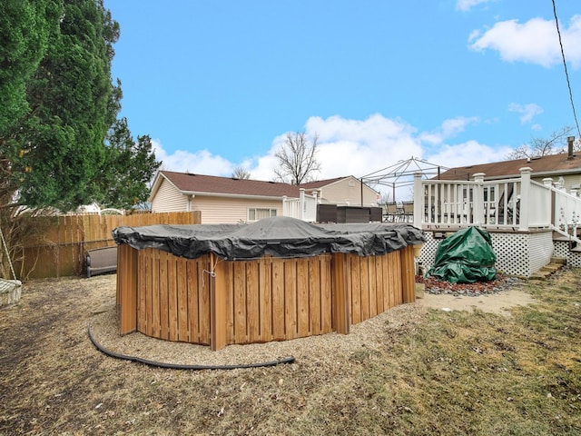 view of yard featuring a wooden deck and a hot tub