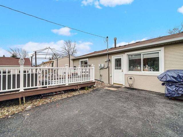 rear view of house featuring a deck