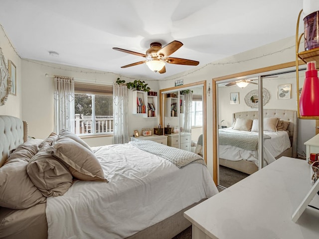 bedroom featuring multiple windows, two closets, and ceiling fan