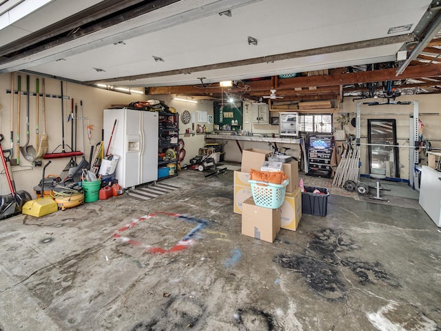 garage with a workshop area and white fridge with ice dispenser