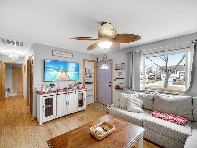 living room featuring ceiling fan and light wood-type flooring