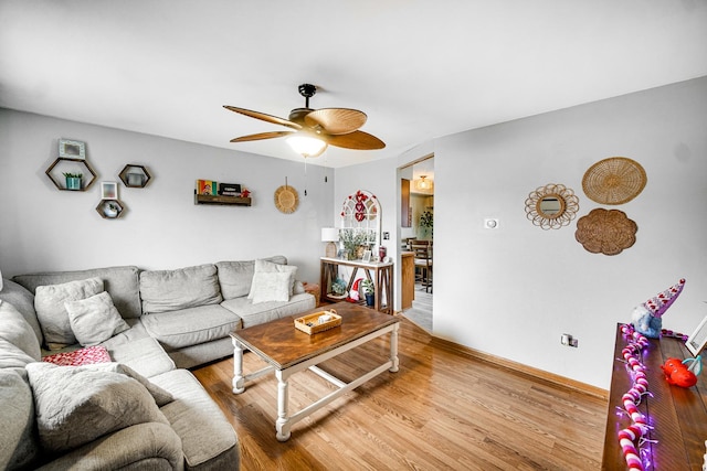 living room with ceiling fan and wood-type flooring