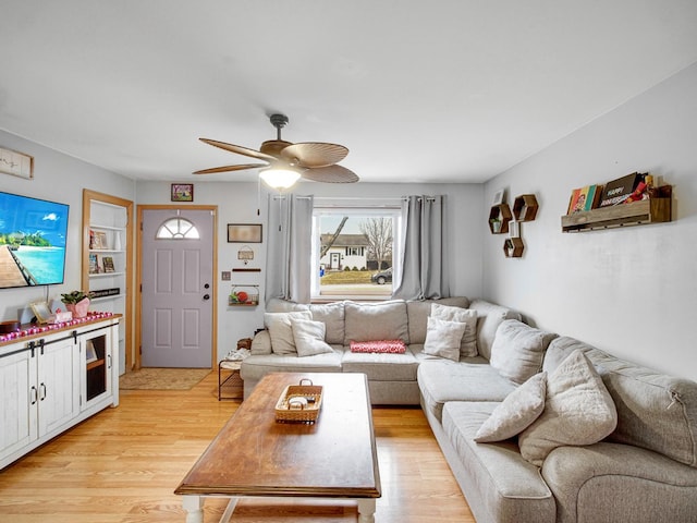 living room featuring ceiling fan and light hardwood / wood-style flooring