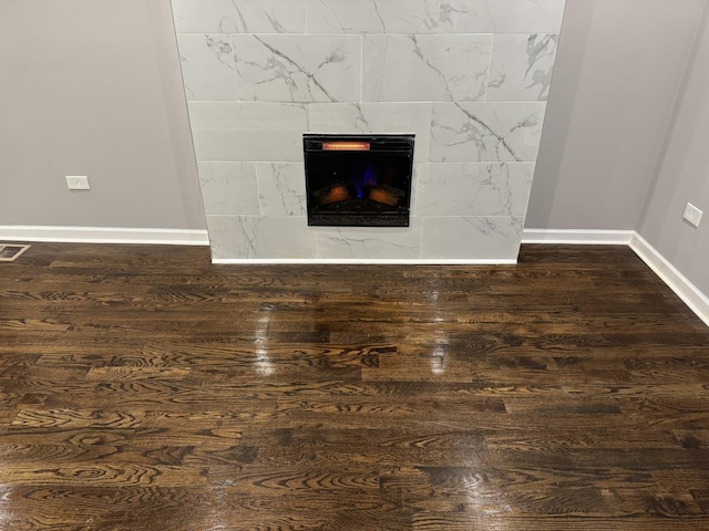 room details with hardwood / wood-style flooring and a tile fireplace