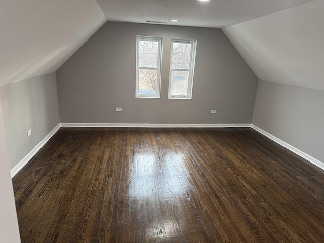 bonus room featuring lofted ceiling and dark hardwood / wood-style floors