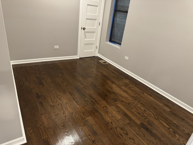 unfurnished room featuring dark hardwood / wood-style floors