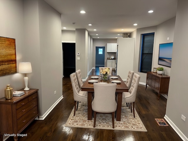 dining area featuring dark wood-type flooring