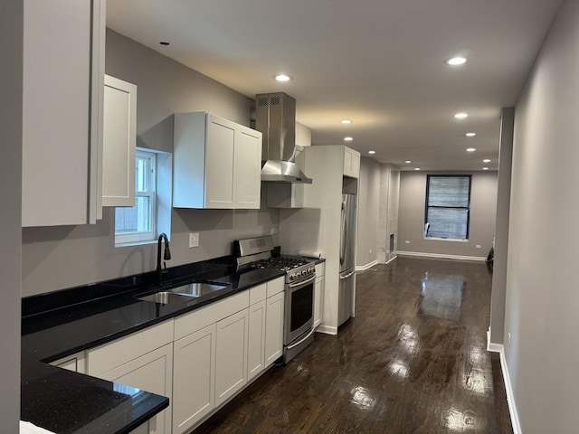 kitchen featuring white cabinetry, sink, wall chimney exhaust hood, and appliances with stainless steel finishes