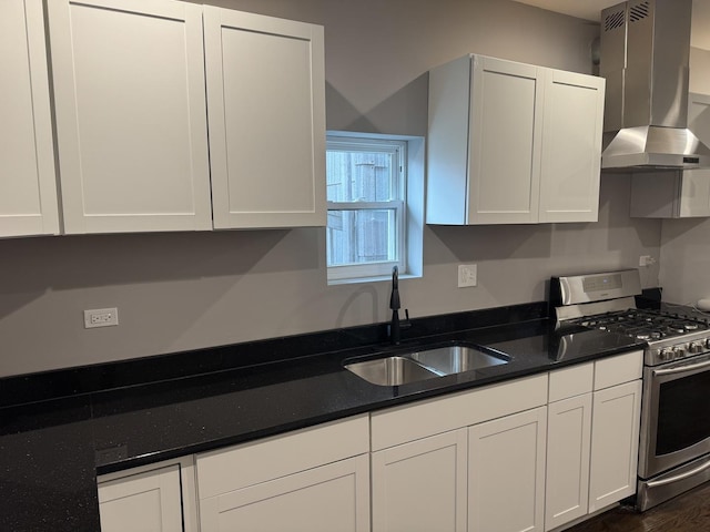 kitchen featuring white cabinetry, range hood, stainless steel gas range, and sink