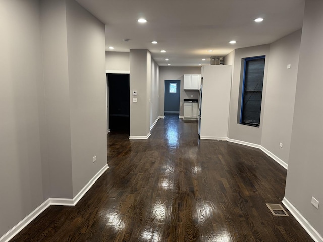 unfurnished living room featuring dark hardwood / wood-style flooring