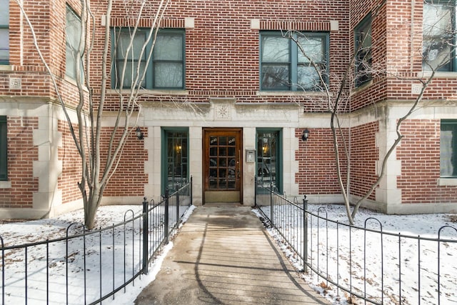 view of snow covered property entrance