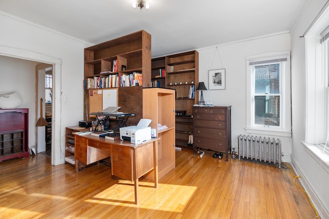 office with crown molding, radiator heating unit, wood-type flooring, and plenty of natural light